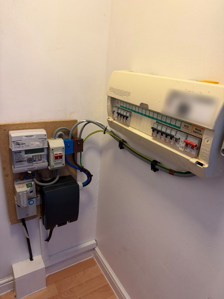 Consumer unit, meter and split meter tails on an EV charger installation in Bromley